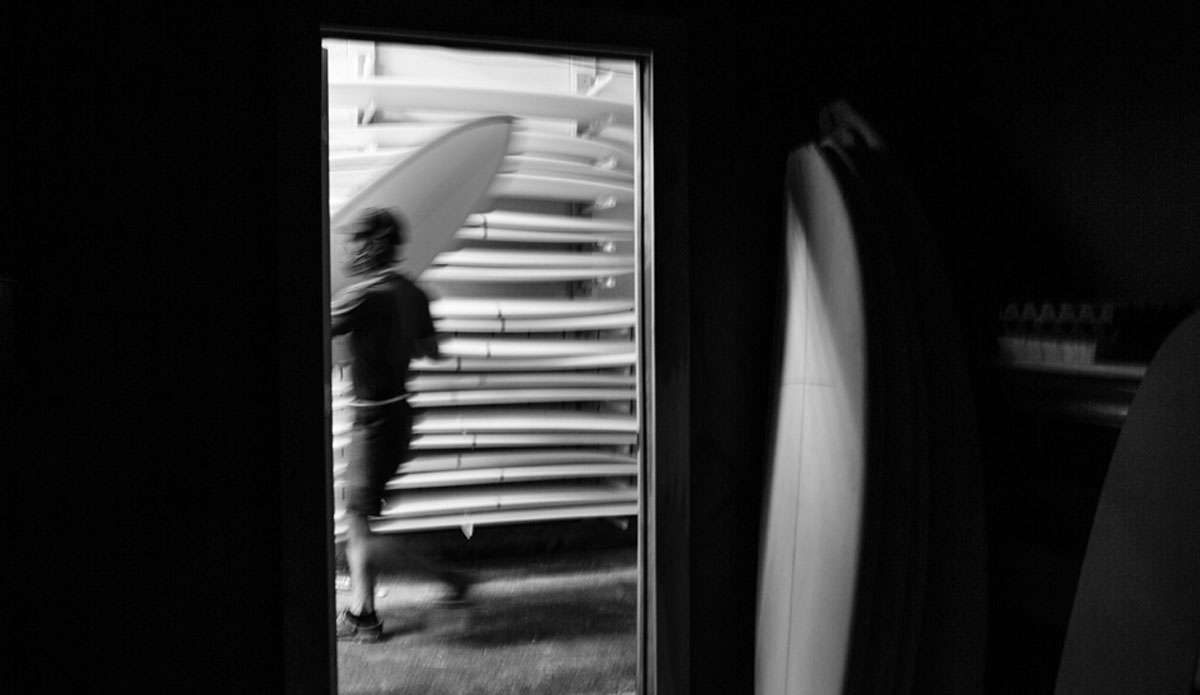 Phil Browne adding a freshly sanded board to the rack. Photo: <a href=\"https://www.christorphotography.com/\">Christor Lukasiewicz</a>