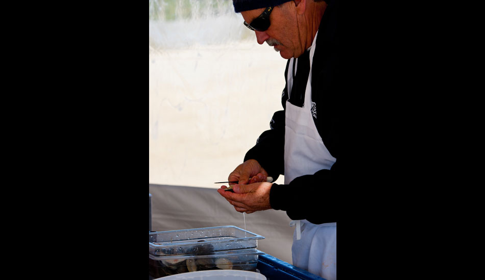 Bob Nugent, owner of the Black Whale restaurant, shucks clams for competitors and spectators to snack on. Bob is also a competitor in the annual event. Photo: Kyle Gronostajski