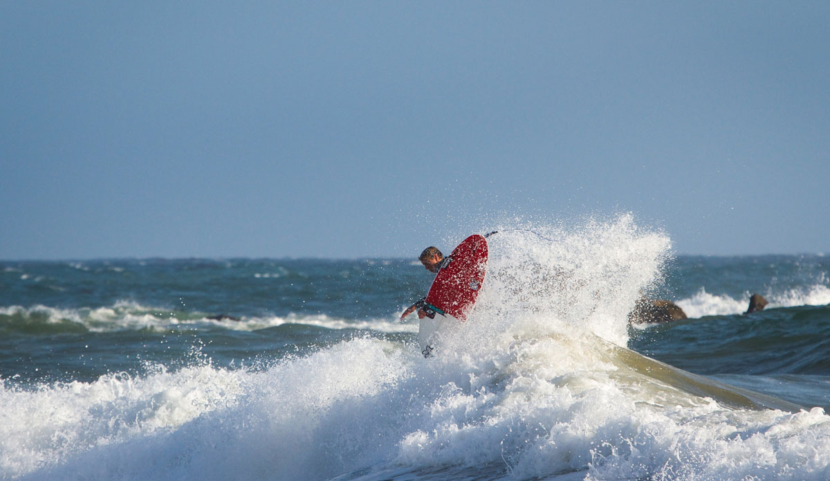 Small pulses, big moves. Braden Jones launching against the winds. Photo: <a href=\"https://www.colinnearman.com\">Colin Nearman</a>