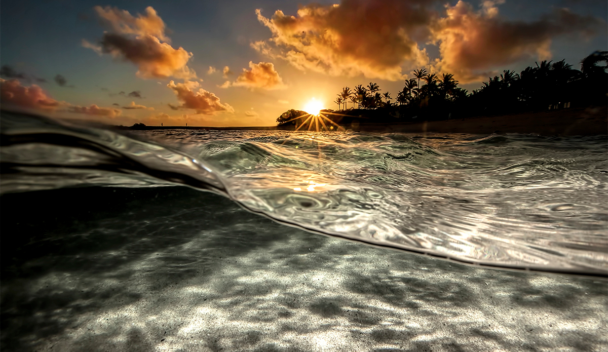 Morning sun breaking the night, island style. Photo: <a href=\"https://craiglarsonimaging.com/\">Craig Larson</a>