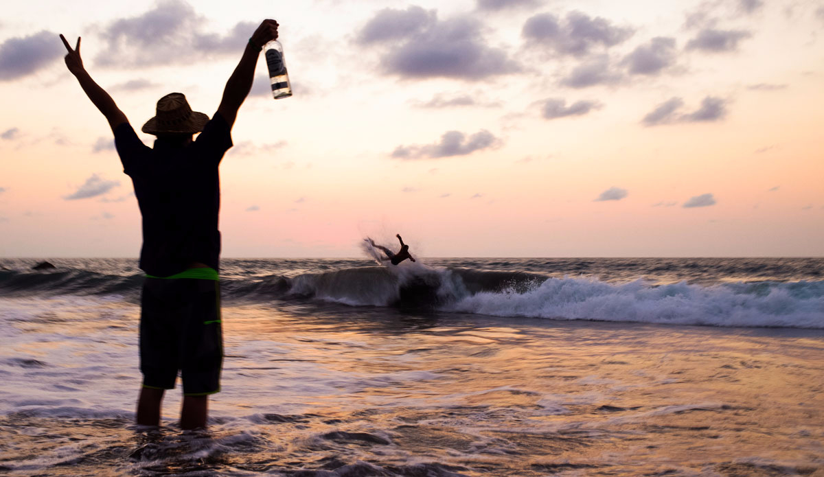 An injured Alex Gray throwing maximum aloha at Luke Davis – punting in the shore break. Photo: Peterson  