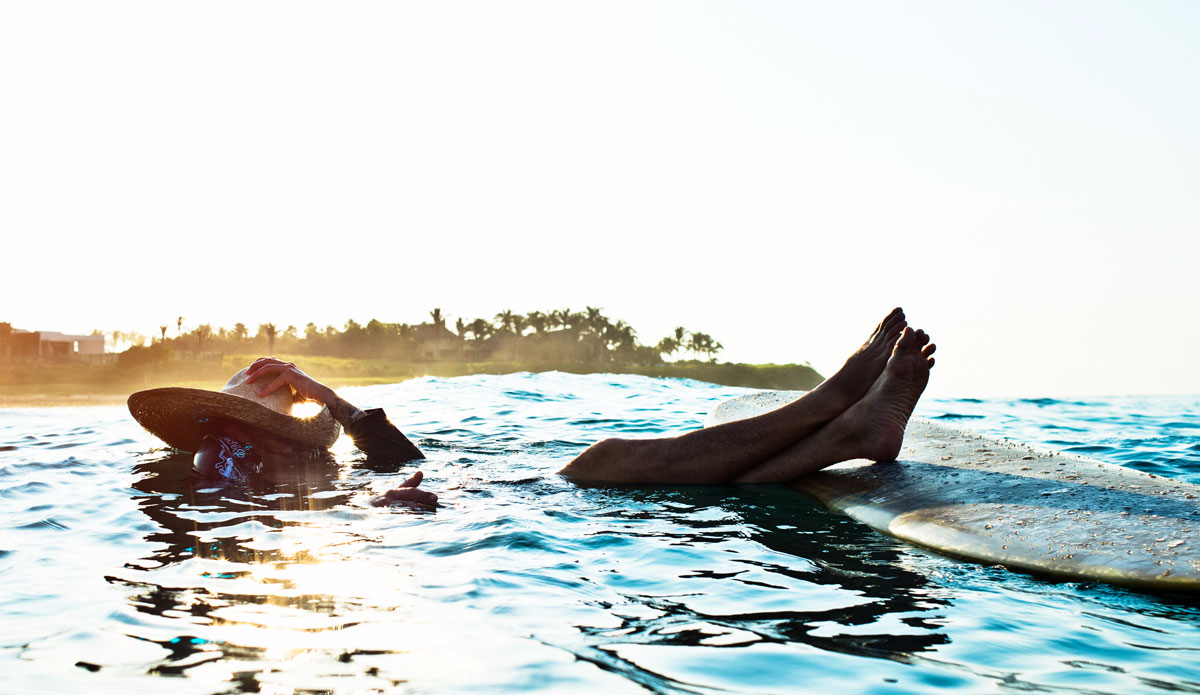 Continuous early morning surf sessions coupled with late night dinner parties had the crew surfed out and sun burned. Colin takes a moment to hide from the sun. Photo: Peterson  