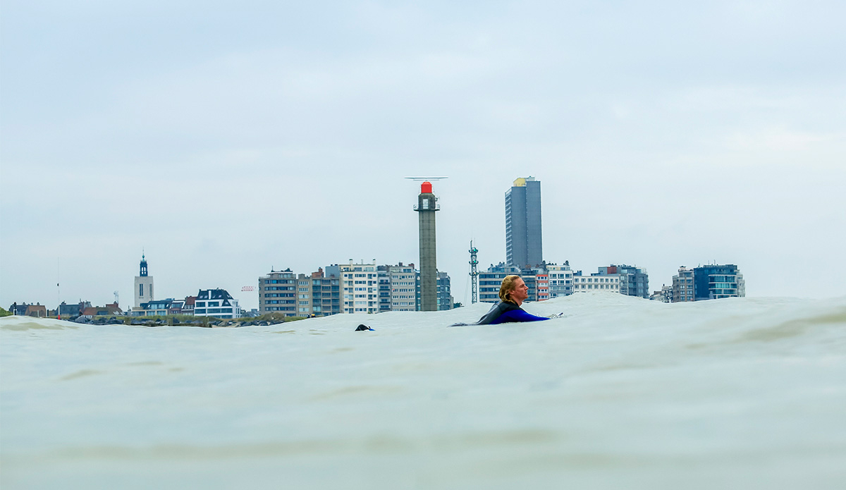 This is the beautiful city of Ostend in the country of Belgium. It’s the town with the largest surf scene.  You can see part of it in the background while surfer Hannes Hamelton is paddling right by me focusing on his next wave to catch. Photo: Damian Davila