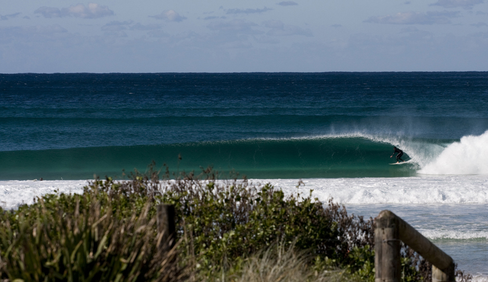 NSW. Local, Mick Moltzen pulling in. This beachbreak, near my home in Northern NSW, lights up under certain conditions to provide spectacularly luminous tubes. I love the refracted light at the base of the wave, a combination of time of day, whitish sand, clear water and west wind. Image: <a href=\"https://www.sparkesphoto.com\" target=\"_blank\">Sparkes</a>  

