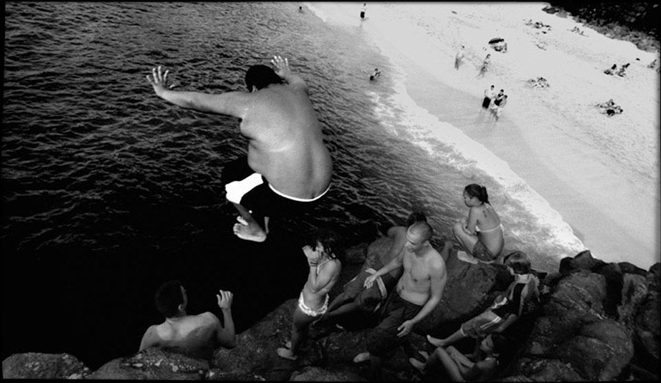 Jump Rock, Waimea Bay. I love that spot. Huge Waimea to little shorebreak days to days like this, they\'re all fun, and sometimes these pancake days were the most fun by far! Photo: <a href=\"http://www.submerge.com.au\" target=_blank>Dean Dampney</a>.