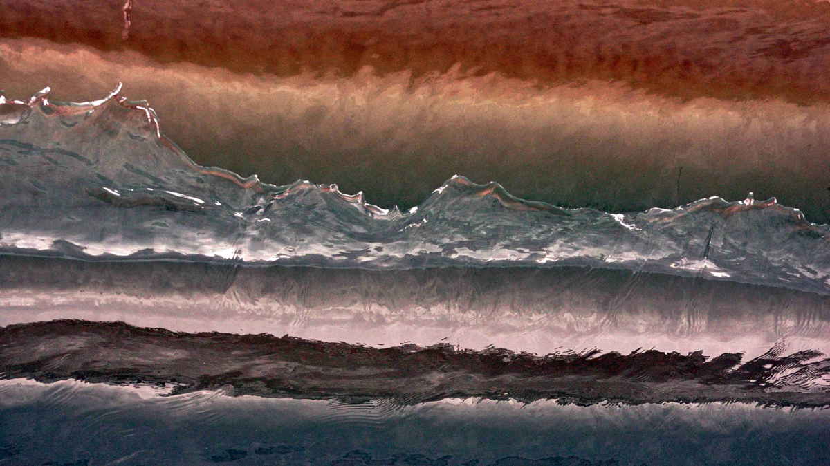 The illusion of a Mountain range caught in the face of a six inch wave. Photo: <a href=\"https://debmwaveart.webs.com/\">Deb Morris</a>