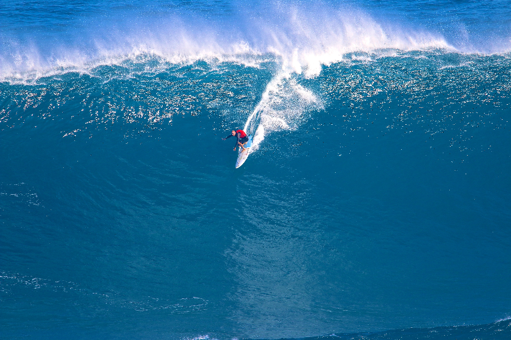 Shane Dorian surfs Peahi different than everyone else. He sits out past the pack and always is on the best one. He might only catch 2 waves in 4 hours but they are the best 2 waves all day.