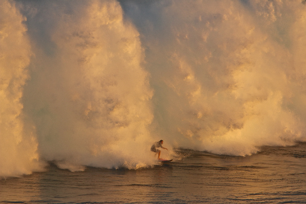 Unknown getting a morning mow down. Great lighting in the morning at Peahi.