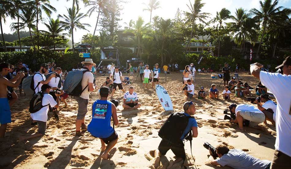 Mick Fanning, meditates before his heat with a circle of photographers capturing the moment. Photo: <a href=\"https://mattdunbar.com.au\">Matt Dunbar</a>
