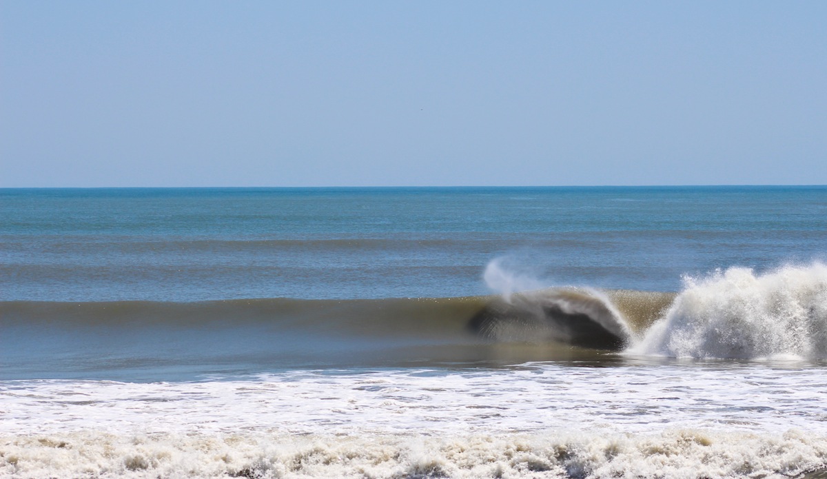This is one of my favorites from the session. Check out the ripples on the wave face from the spitting barrel. That\'s as clean as it gets on the Outer Banks. Photo: <a href=\"https://jettylife.com/\">John Streit.</a>