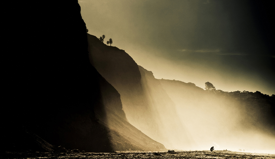 I believe this is Tim Tebow just moments before paddling out at Blacks Beach. One of those days when the mist from the waves get pushed against the cliffs to make for some dramactic light. Easily one of my favorite beaches in the world. Photo: <a href=\"https://9mphoto.com/\" target=_blank>Myles McGuinness</a>
