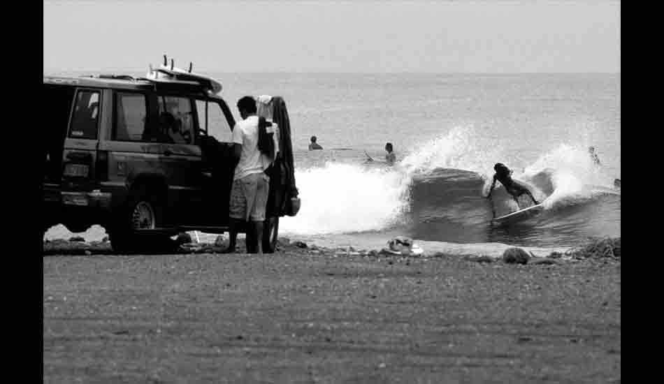 January 2001 - Jamaican local, Inilek Wilmot, cuts loose on a wave down the road from his home at the Jamnesia Surf Camp in Bull Bay, Kingston, Jamaica. This wave, at the time the premiere break on the island, was destroyed by Hurricane Ivan in September of 2004 when the entire cobblestone point was moved down the coast.  However, the destruction was not completed before Inilek\'s father, Billy Wilmot, surfed the largest wave ever caught in Jamaica, and this break has since made something of a comeback in the last couple years although not nearly on the level of its former glory. Image: <a href=\"https://stevefitzpatrick.com/\" target=\"_blank\">Fitzpatrick</a>  