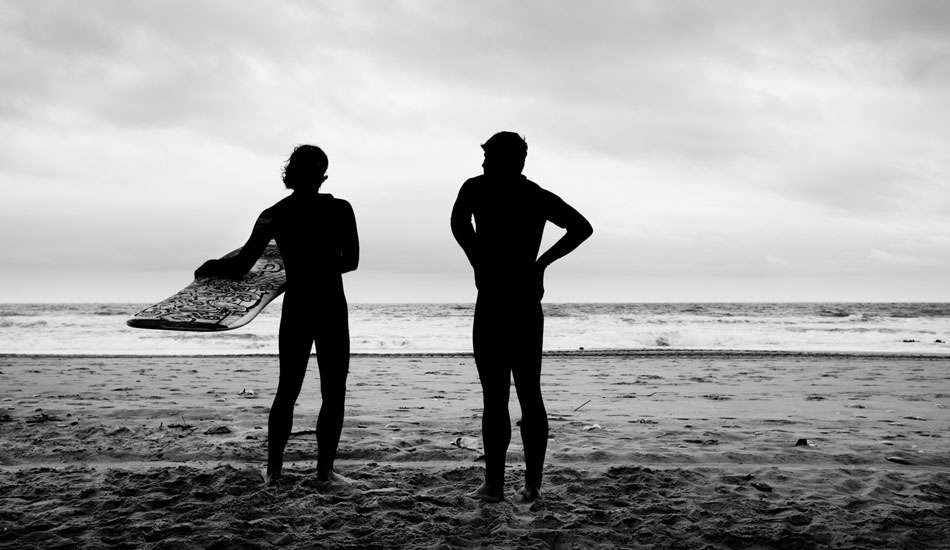 Surfers in silhouette. Photo: <a href=\"https://www.forestwoodward.com\">Forest Woodward</a>