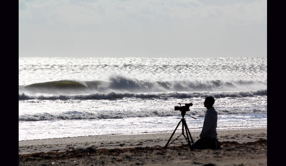 S Turns, OBX, NC, 2011. Joe Cheshire contemplating weather to surf or film. He shortly packed up his equipment and choose to surf. Photo: <a href=\"https://www.chrisfrickphotography.com/\" target=_blank>Chris Frick</a>
