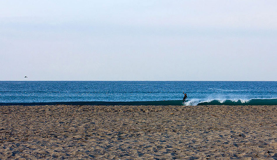 Unknown longboarder enjoying the early morning solitude. Photo: <a href=\"https://www.gagehingeley.com/\" target=_blank>Gage Hingeley</a>.
