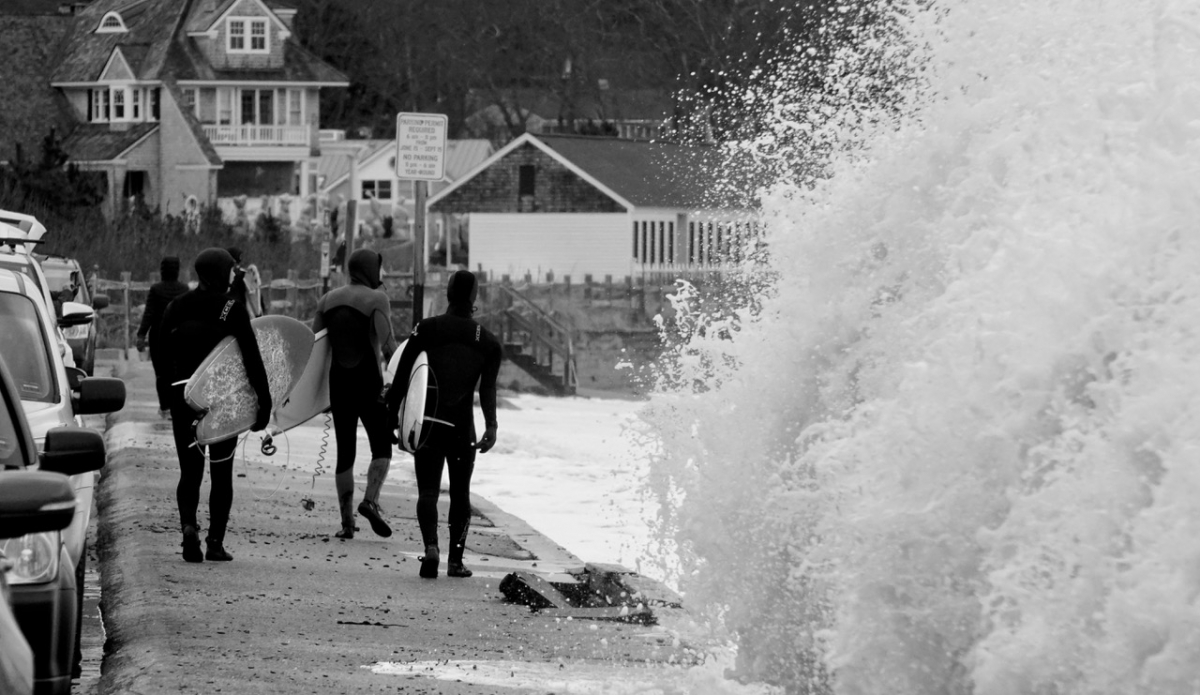 A few minutes after this breach, the police shut down all road access and the seawall collapsed. These guys never even looked back.  I stayed tucked in some bushes next to one of the beach houses and got another hour of photos while the police patrolled the street. Photo: Christopher Gauthier

