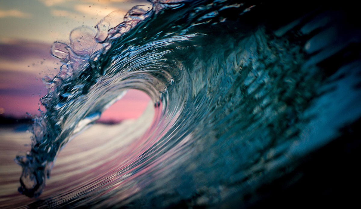 The pastel reflections in this night’s sky painted the waves with pink, purple and teal.  The ocean’s color palette never ceases to surprise me. Photo: <a href=\"https://www.surferphotos.com/\">Graham Hunt</a>
