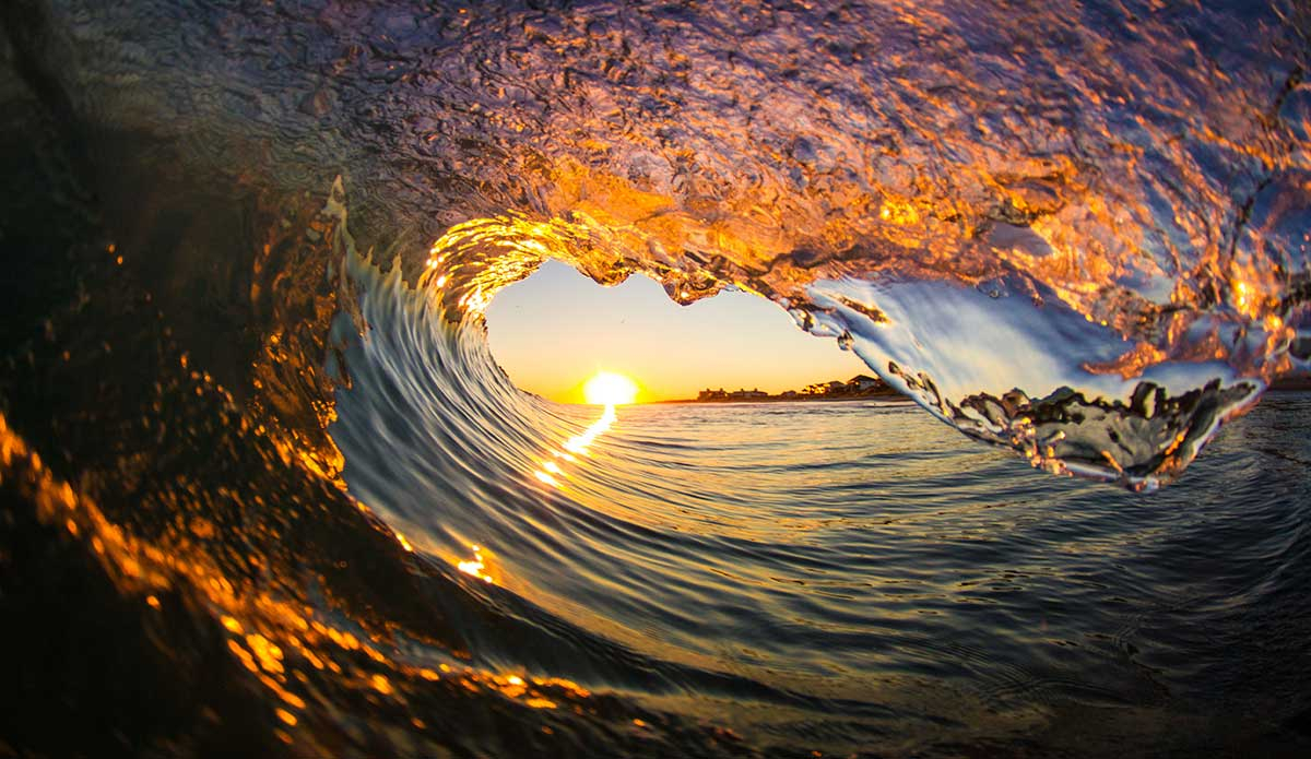 I really like how you can see the reflection of the oceanfront homes in the lip of the wave and the different colors you can capture at sunset. Photo: <a href=\"https://www.surferphotos.com/\">Graham Hunt</a>