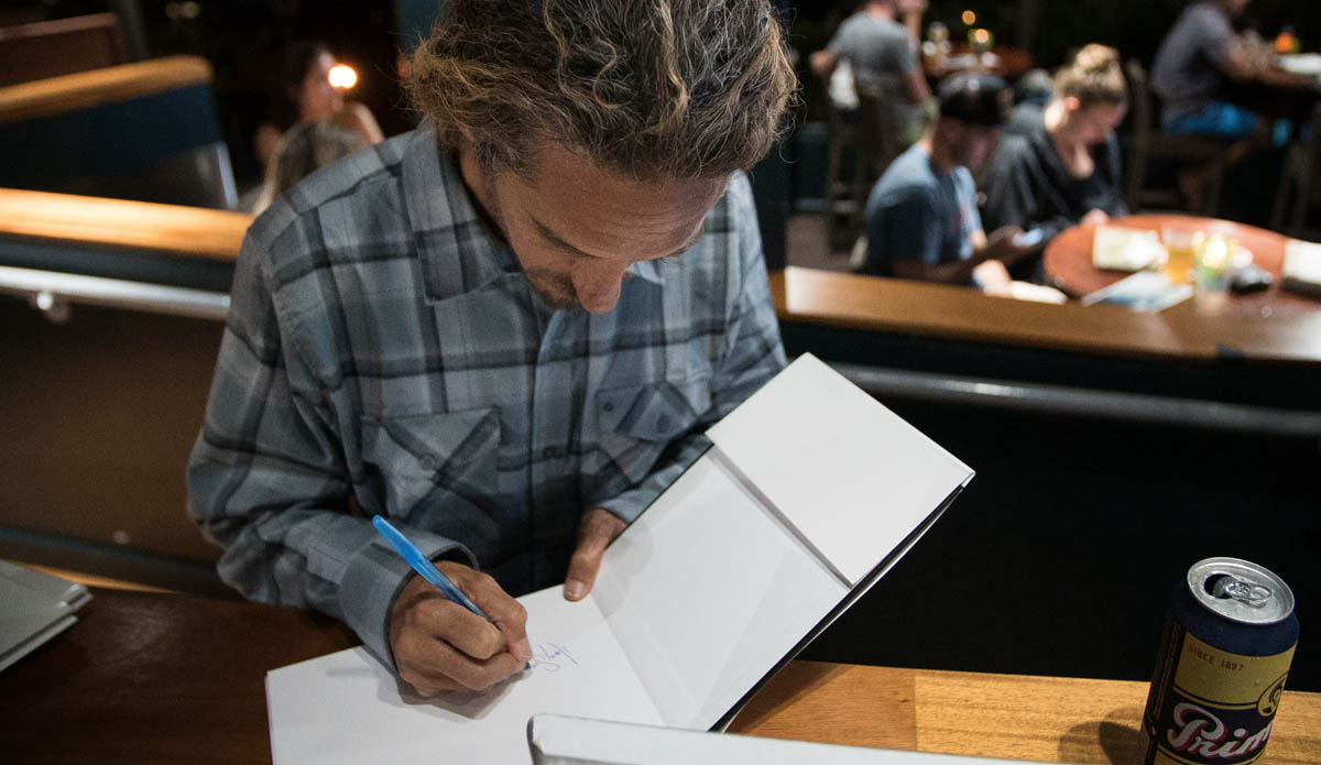 Following the film, we gave away a bunch of free stuff, including The Inertia\'s 5-year anniversary book signed by Rob Machado himself. Photo: Juicewhale