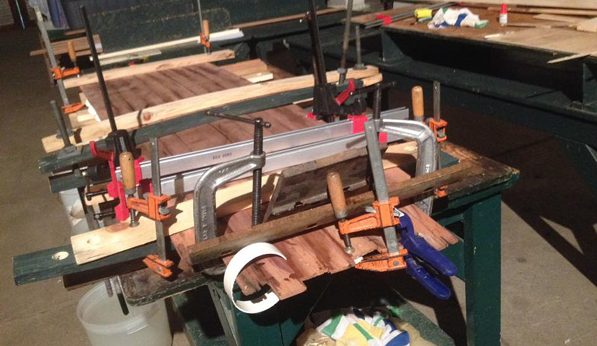 Clamping the deck and bottom to the skeleton by all means necessary—threaded rods, G-clamps, strips of PVC pipe, and later, those water bins on top.