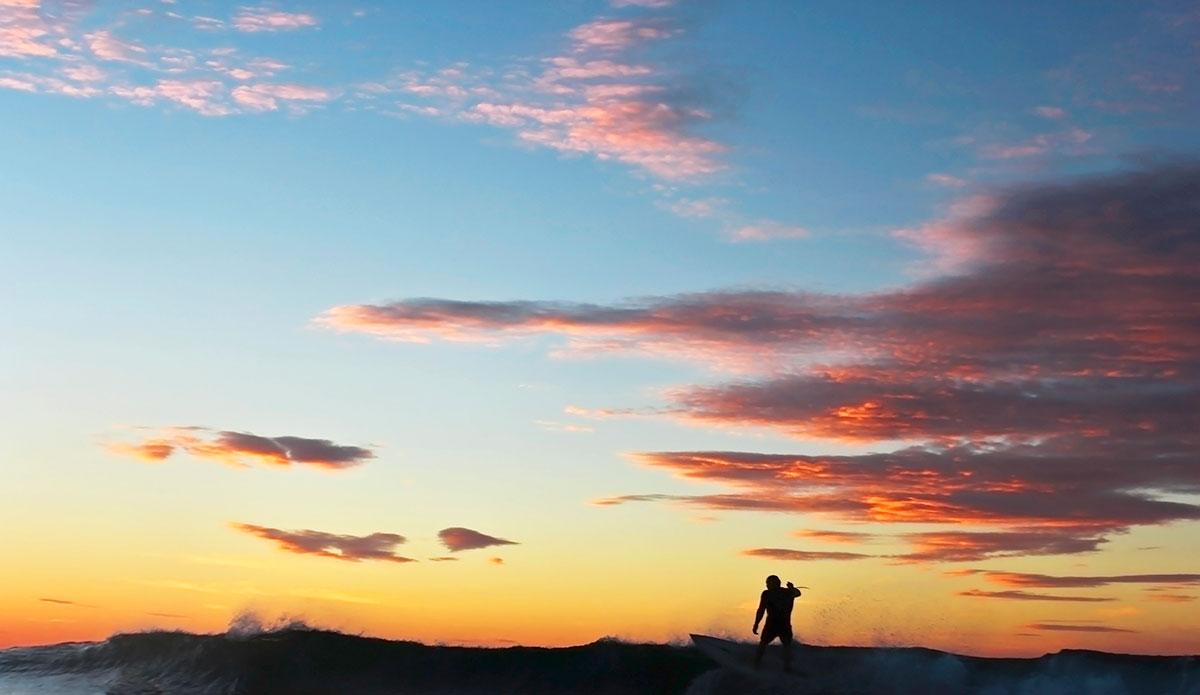 Silhouette of a surfer at Long Reef, Sydney. Photo: <a href=\"https://www.hollytreephoto.com/\">Holly Shoebridge</a>