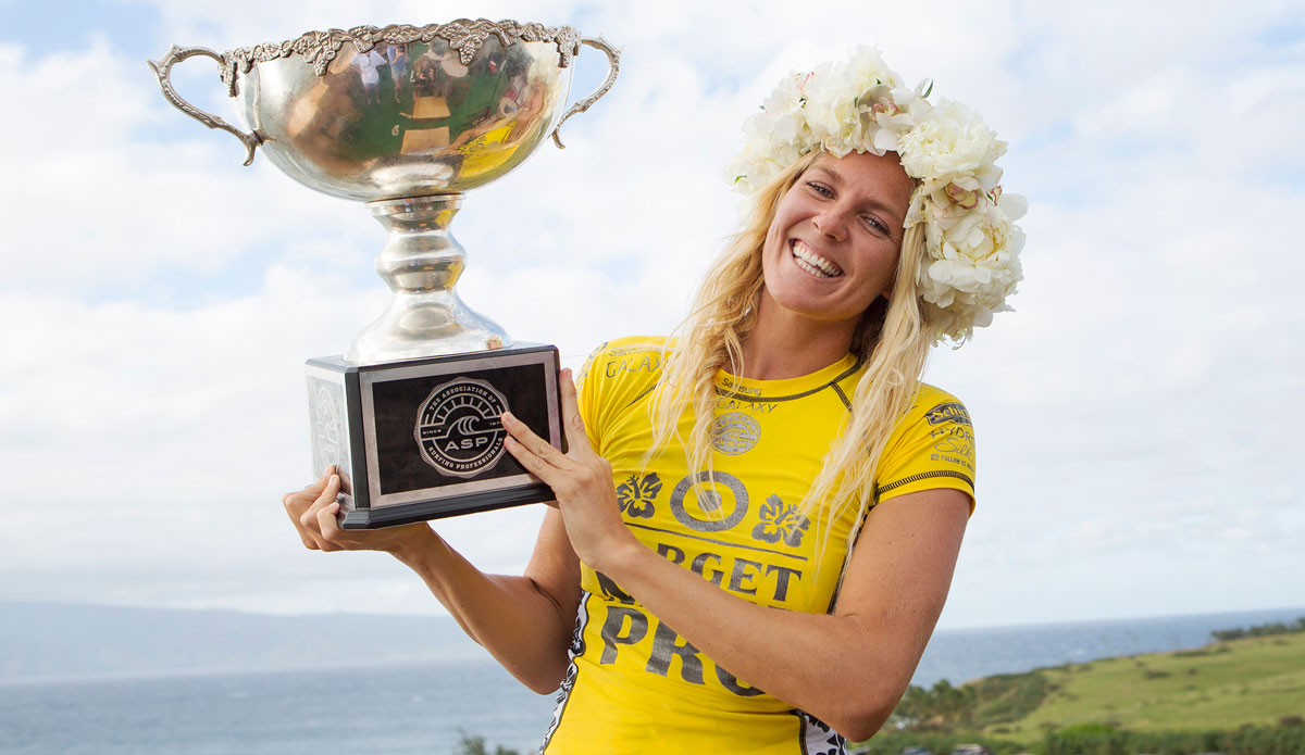 Stephanie Gilmore of Tweed Head, NSW, Australia holds her 2014 ASP World Title trophy after clinching her sixth ASP World Title at the Target Maui Pro at Honolua Bay, Maui, Hawaii. Photo: <a href=\"https://www.aspworldtour.com/\">ASP/<a href=\"https://www.kirstinscholtz.com/\"> Scholtz</a>