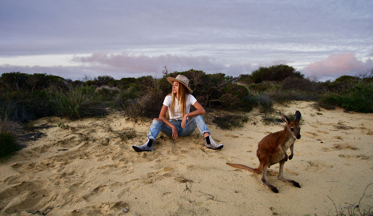 Imogen and Ziggy, her family’s kangaroo. Living as remotely as the Caldwell’s do, stray kangaroos that are abandoned by their parents often find their way onto their property whilst looking for food and water, before quickly becoming situated and relishing the human interaction.  Photo: <a href=\"https://www.morganmaassen.com/\">Morgan Maassen</a>