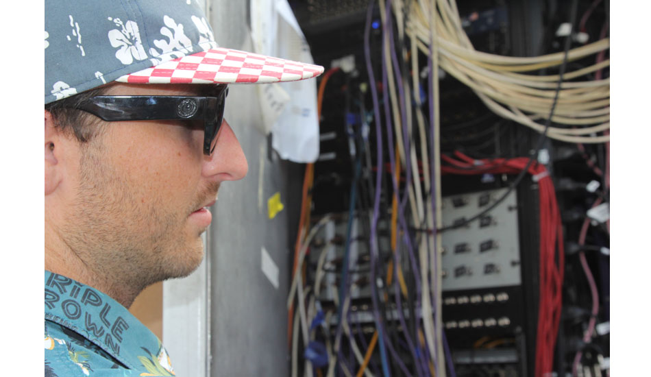 Senior Producer Chris Steblay negotiates a medley of various cords, plugs and outlets–all of which go different places. Stressful job.