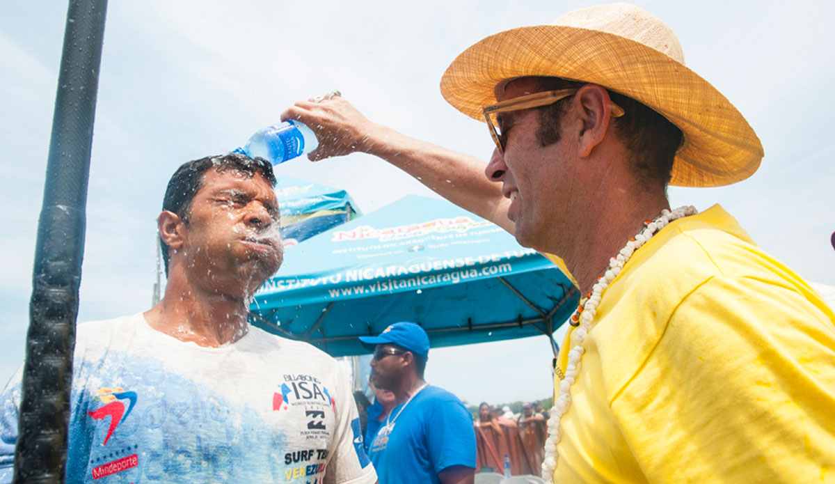 ISA President, Fernando Aguerre, douses a Venezuelan contestant. Photo: <a href=\"https://www.isasurf.org/\"> ISA | Rommel</a>