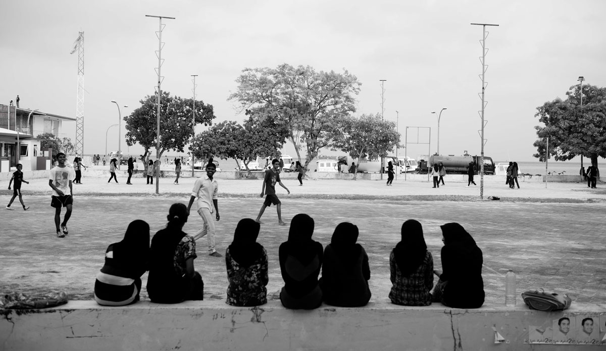 Local Thinadhoo girls watching on as the boys play soccer before holy day (friday) where the town comes to a halt. Photo: <a href=\"https://www.jackdekortphoto.com.au/\">Jack Dekort</a>