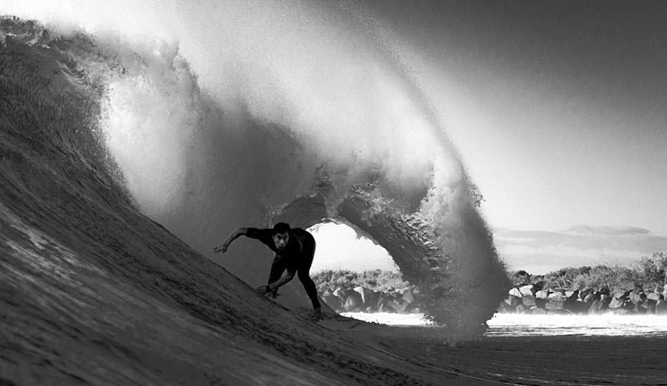 Pulling in under a heavy lip - D\'Bah. Photo: <a href=\"https://jamesrheinbergerphoto.com\">James Rheinberger</a>