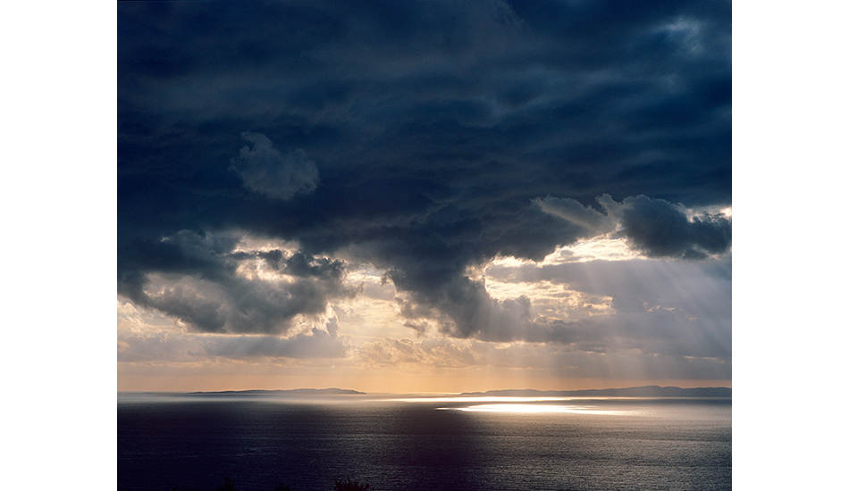 Dark cloud over Paxi Island. Ionian Sea, Greece. Photo: <a href=\"http://www.joecurren.com\" target=_blank>Joe Curren</a>