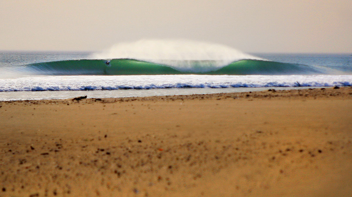 This ones pretty old, but I always enjoy looking at it. It was during the fire swells and still to this day I have never seen a more perfect beach break anywhere. Photo: <a href=\"https://aladdinsurfmag.net/\"> Foster </a>