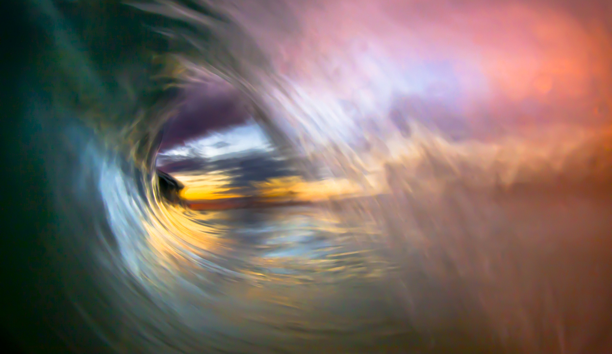 A perfect barrel framing the rich colors of the sunset and clouds on the horizon.  My favorite photo to date. Photo: <a href=\"https://www.LucarelliPhoto.com/\"> John Lucarelli</a>