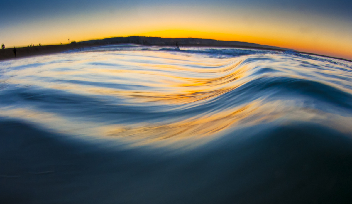 The water ripples with color as the sun creeps over the horizon. Photo: <a href=\"https://www.LucarelliPhoto.com/\"> John Lucarelli</a>