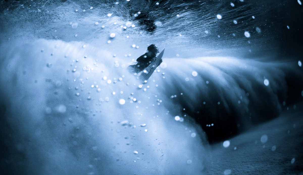 Duck dive surf rising to the top.  Photo: <a href=\"https://www.jonwrightphoto.com\">JonWrightPhoto.com</a>