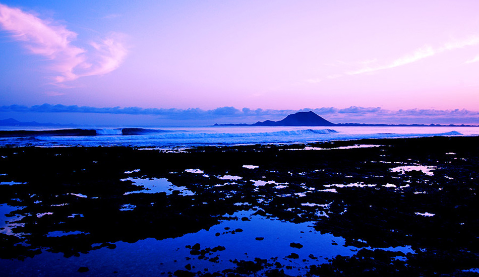A view from Fuerteventura, Canary Islands, looking north towards Lobos Island, which is well known for its surf. Photo: <a href=\"https://www.jordanweeks.com/\" target=_blank>Jordan Weeks</a>