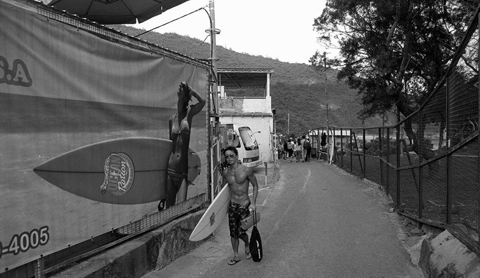 Local surfer heading out. Photo: <a href=\"https://www.stephenarthurmilner.com\">Stephen Milner</a>