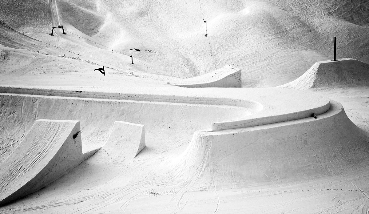Peetu Piiroinen jumping over a ridiculously large and immaculate Nike swoosh made of snow at the Nike Chosen Sessions in Austria.  Photo: <a href=\"https://lauraaustin.4ormat.com/\">Laura Austin</a>