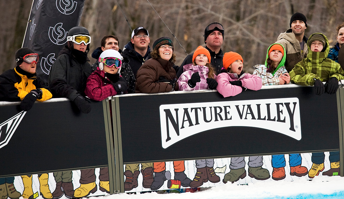 This one was shot during the halfpipe finals at the US Open. Instead of shooting the snowboarder I decided to take a picture of the crowd while the rider was soaring high above them. The main reason I love this photo is because of the girl not even looking at the rider, who appears to be screaming at the top of her lungs. The cartoon feet at the bottom don\'t hurt either. I laugh every time I see this one. Photo: <a href=\"https://lauraaustin.4ormat.com/\">Laura Austin</a>