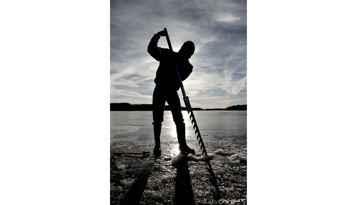 Digging holes in the ice with an ice saw. Photo: <a href=\"https://liabarrettphotography.com/\" target=_blank>Lia Barrett</a>