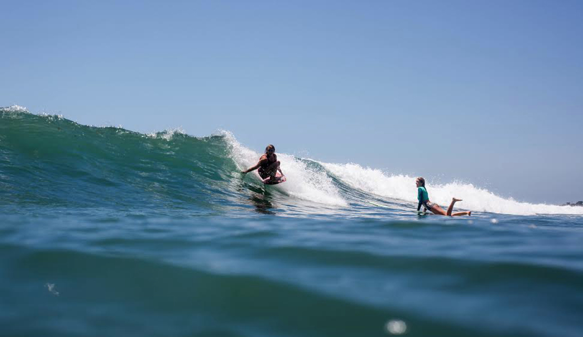 It\'s rare to see Hallie Rohr on her backhand because she rides switch better than anyone I know (guys included). She has a very quiet manner and lets her surfing get the attention (as you can see by Luki Okeefe\'s face). Typically, that gorgeous face of Luki\'s would be behind the camera, but here she is getting a few waves with Hallie. Also, Lukie is one very talented up-and-coming photographers to keep an eye out for. Photo: Amber Mozo