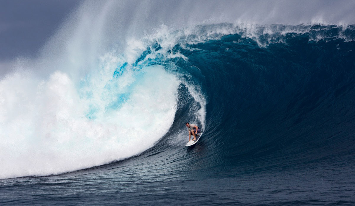 Oahu big wave surfer Makua Rothman on a giant Cloudbreak, Fiji, wave during the “Filthy Friday” session. This image was taken during a very significant swell that hit a few years back in the Pacific. It was by far one of the largest days I had seen in surfing history. I was honored to be there with my camera. Photo: <a href=\"https://www.luciagriggi.com\" target=\"_blank\">Lucia Griggi</a>