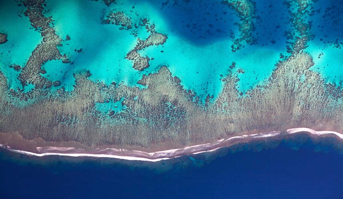 Forty miles out to sea, an open ocean swell roars over the abrupt reef at Cloudbreak, Fiji. I love shooting aerials. I was lucky enough to photograph for the Fijian Tourism Board and was flown around to shoot the beauty of the land. Photo: <a href=\"https://www.luciagriggi.com\" target=\"_blank\">Lucia Griggi</a>