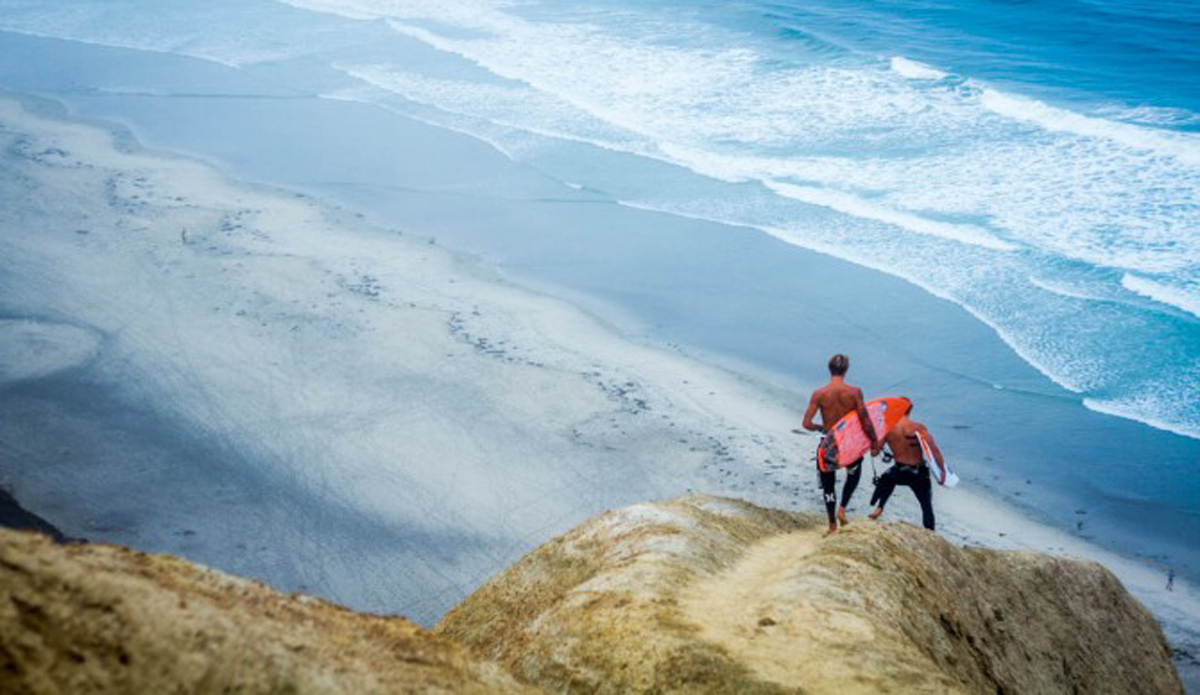 Addy Giddings & Tommy Cantrell heading down the billy goat trail to find some waves.