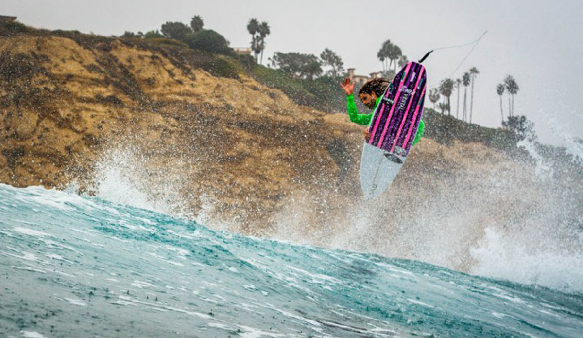 An unknown surfer trying to soar above the cliffs.