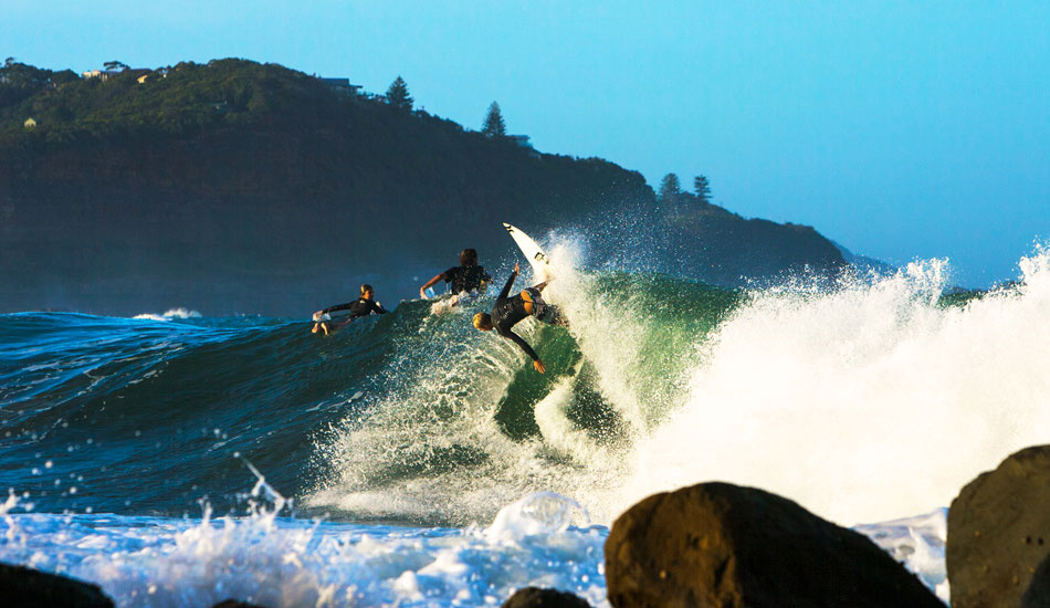 Ace Buchan at Avoca Point, his local break, showing a couple of groms his phenomenal backhand. Photo: <a href=\"https://www.lukeshadbolt.com/\">Luke Shadbolt</a>