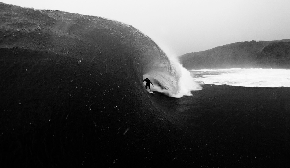 This is a local spot, a place where I cut my teeth learning to shoot. It\'s a great wave to learn to shoot from the water. It\'s really heavy, short, with deep water on either side and gives you a good range to try different lenses depending on the conditions. This is Jay Thompson in the hole. I wasn\'t actually going to shoot this day because of the torrential rain, but it\'s about a 15-minute walk around to this break and I was already wet by the time I got around, so I went out anyway. Stoked I did too, I really like the mood, the rain on the dark face gives it a really ominous vibe. Photo: <a href=\"https://www.lukeshadbolt.com/\">Luke Shadbolt</a>