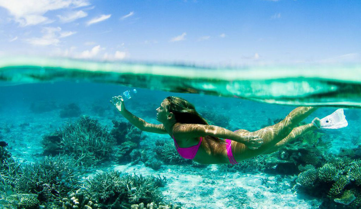 It’s sad to be swimming through paradise and find bottles from all over the world! Eventually they break down and fish eat them, then we eat them. This Odina bikini was made from 10 recycled plastic bottles. Photo: <a href=http://www.vivantvie.com/\">Sarah Lee</a>