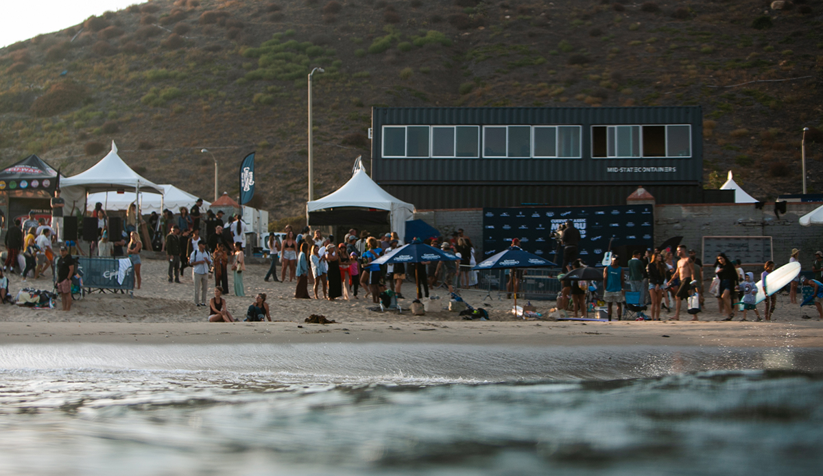 \"The parking lot was still full of its usual characters — people milled about, hanging out in haphazard truck bed conversions and in foldable camping chairs.\"